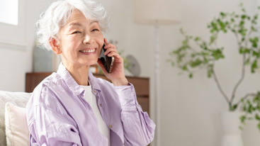 Woman smiling while on the phone in her home