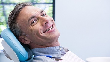 Man with dental implants in Hamden smiling 