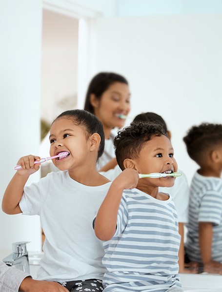 A family brushing their teeth together