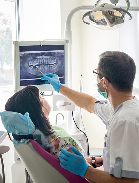 An emergency dentist showing a patient their X-ray