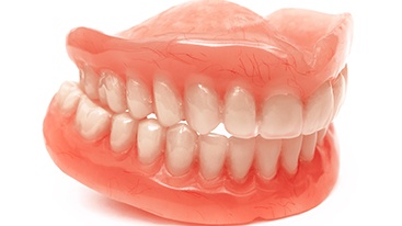 Full set of dentures with a white background