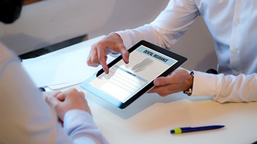 Patient reviewing dental insurance form on tablet