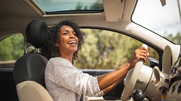 Woman smiling while driving