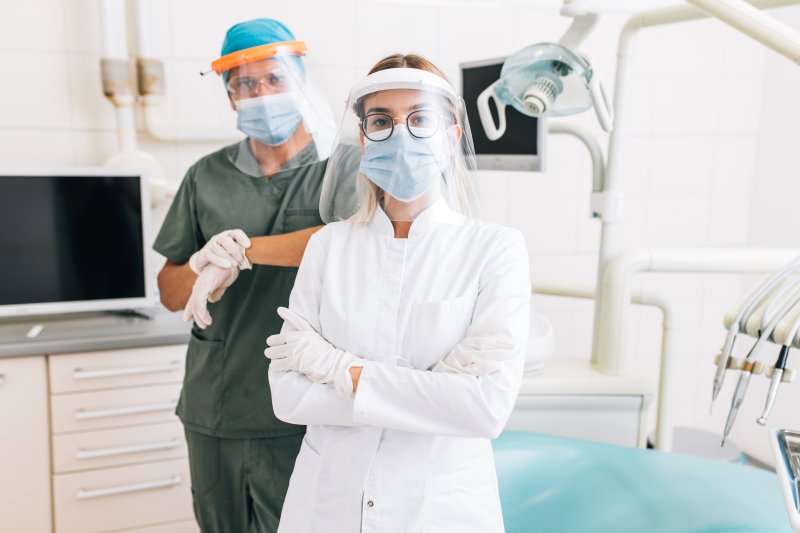 Emergency dentists wearing protective uniforms in a dental office